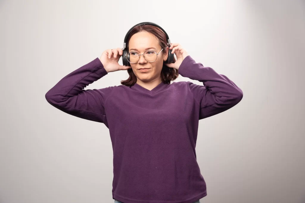 young-woman-with-glasses-listening-music-headphones-white-high-quality-photo
