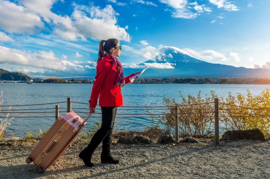 tourist-with-baggage-map-fuji-mountain-kawaguchiko-japan